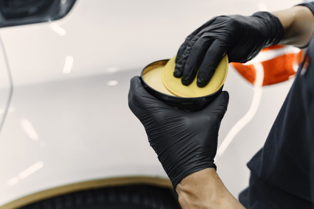 Man polish a car in a garage